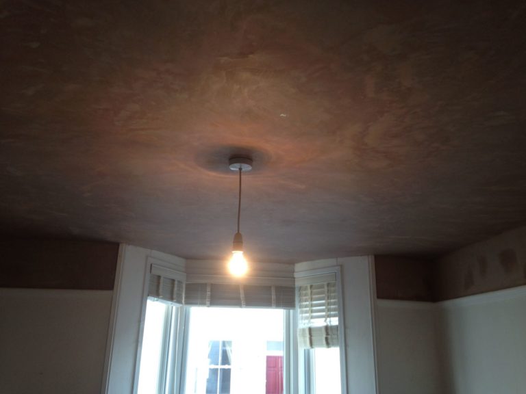 Newly plastered ceiling after a hole had been boarded up.