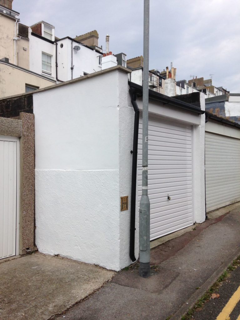 White decorated garage door and side of garage.