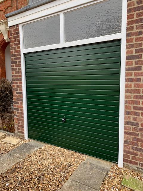 Single Steel (Fir Green) Horizontal Canopy Garage Door with White Frame.