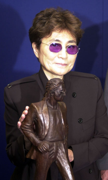 Yoko Ono with statue of John Lennon.