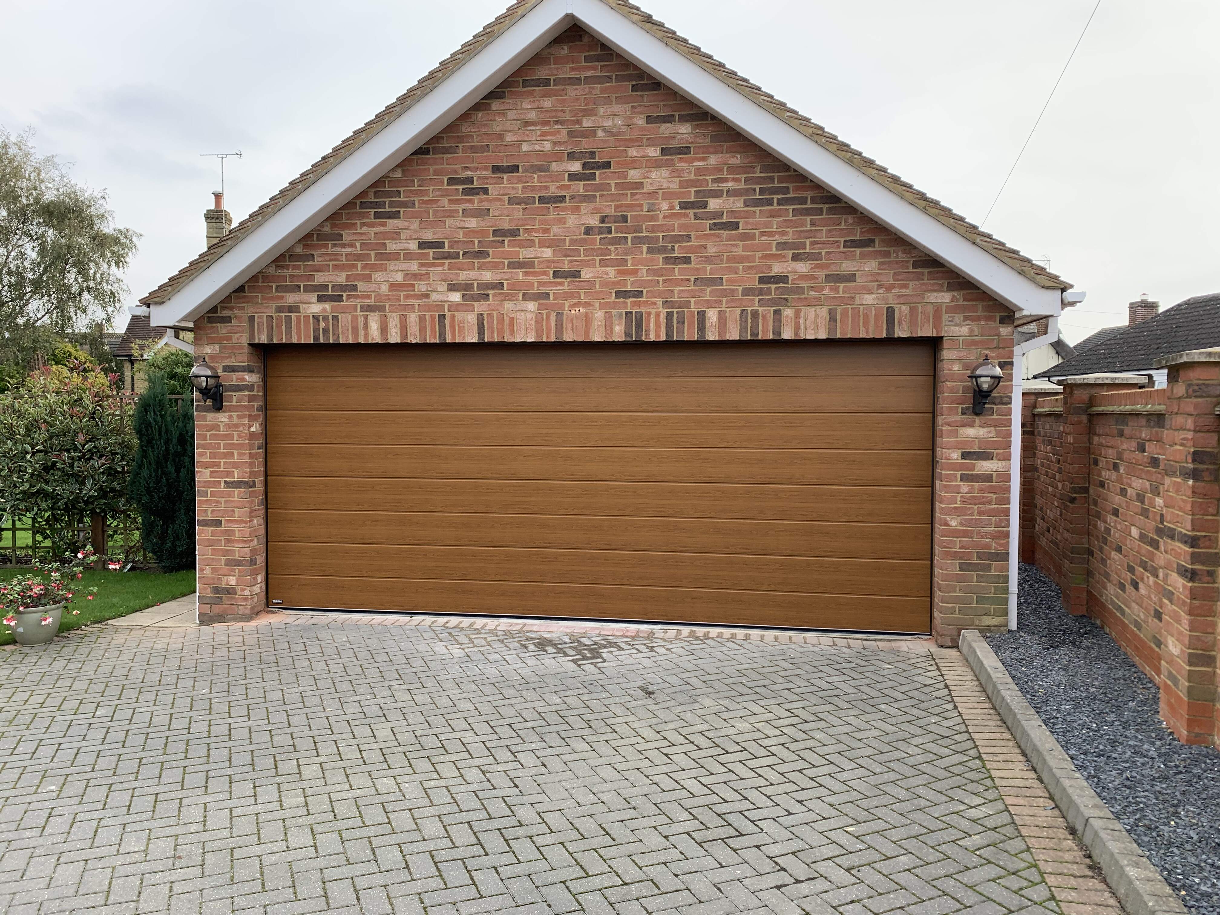 Double Insulated Woodgrain (Golden Oak) M-Ribbed Sectional Garage Door.