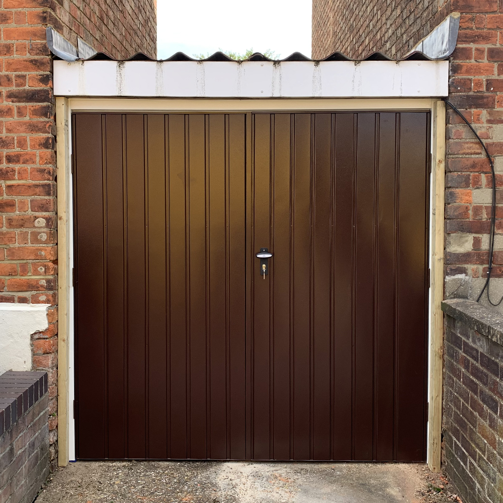 Vertical side hinge garage door finished in brown.