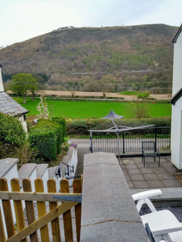 View from the top of Jasmine Cottage's garden looking out to Fron Fawr mountain and Eliseg's Pillar