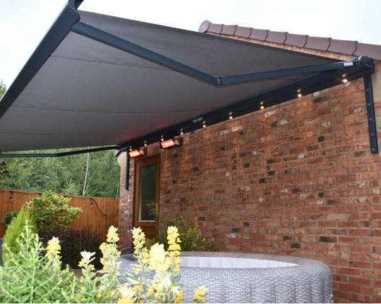 Awning with lights and heaters over hot tub