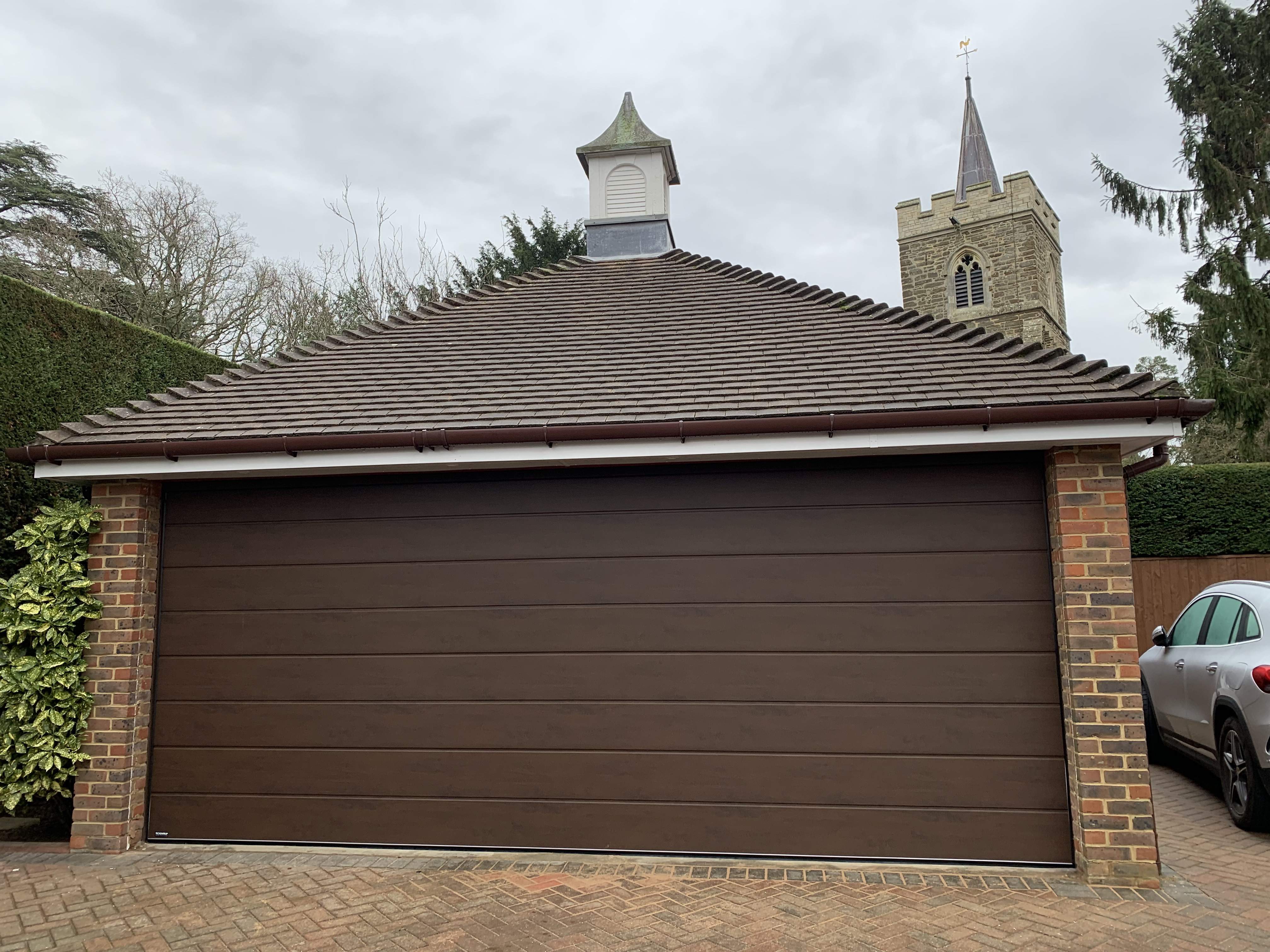 Double Insulated Woodgrain (Dark Oak) M-Ribbed Sectional Garage Door.