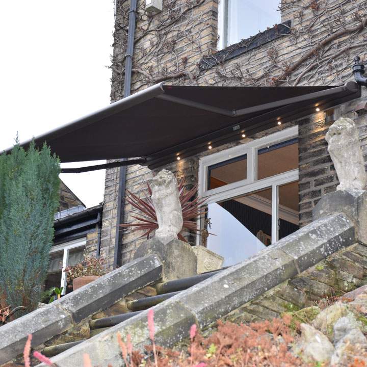 Cassita II Awning in brown on a listed building in Bradford