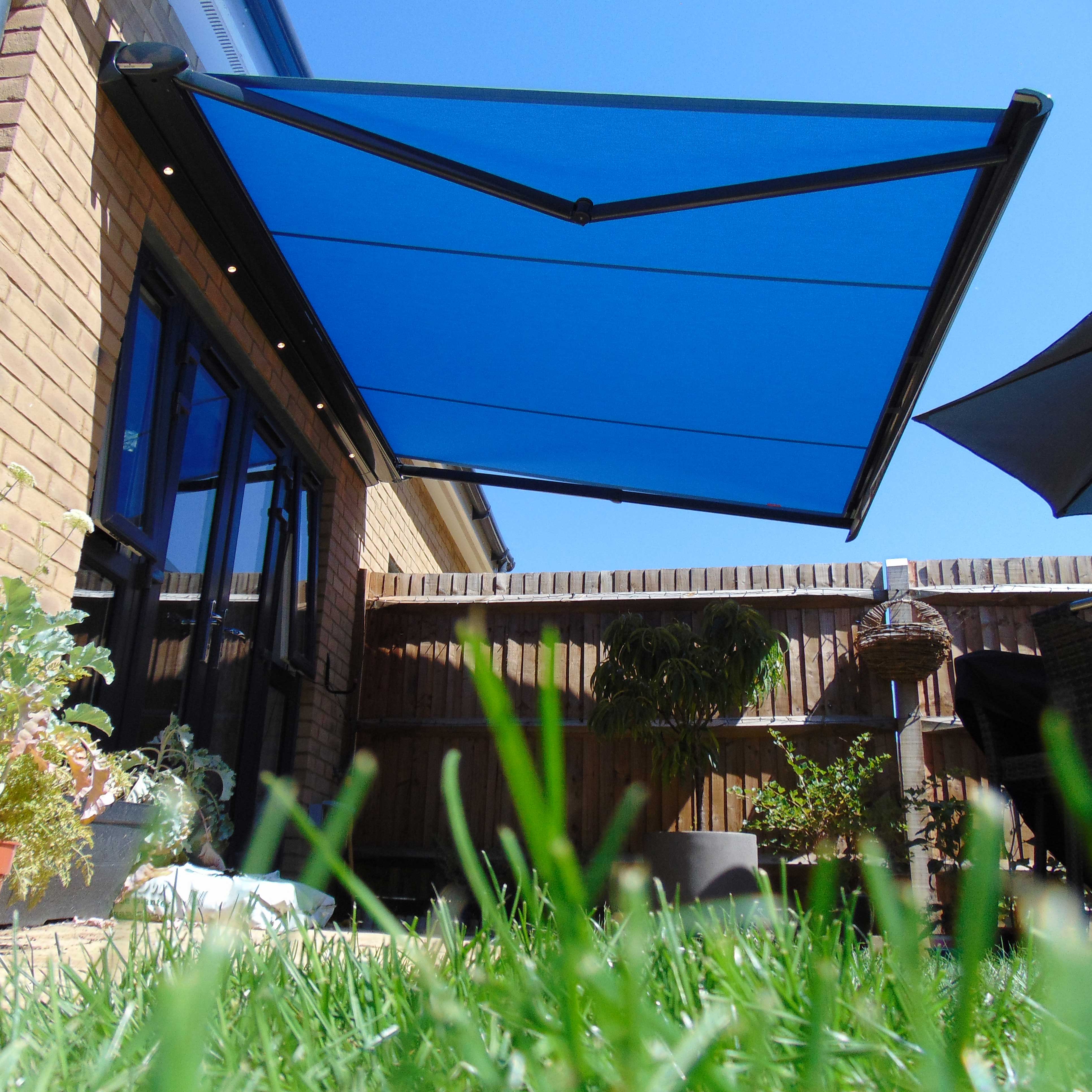 A shaded patio area covered by an Alcas awning