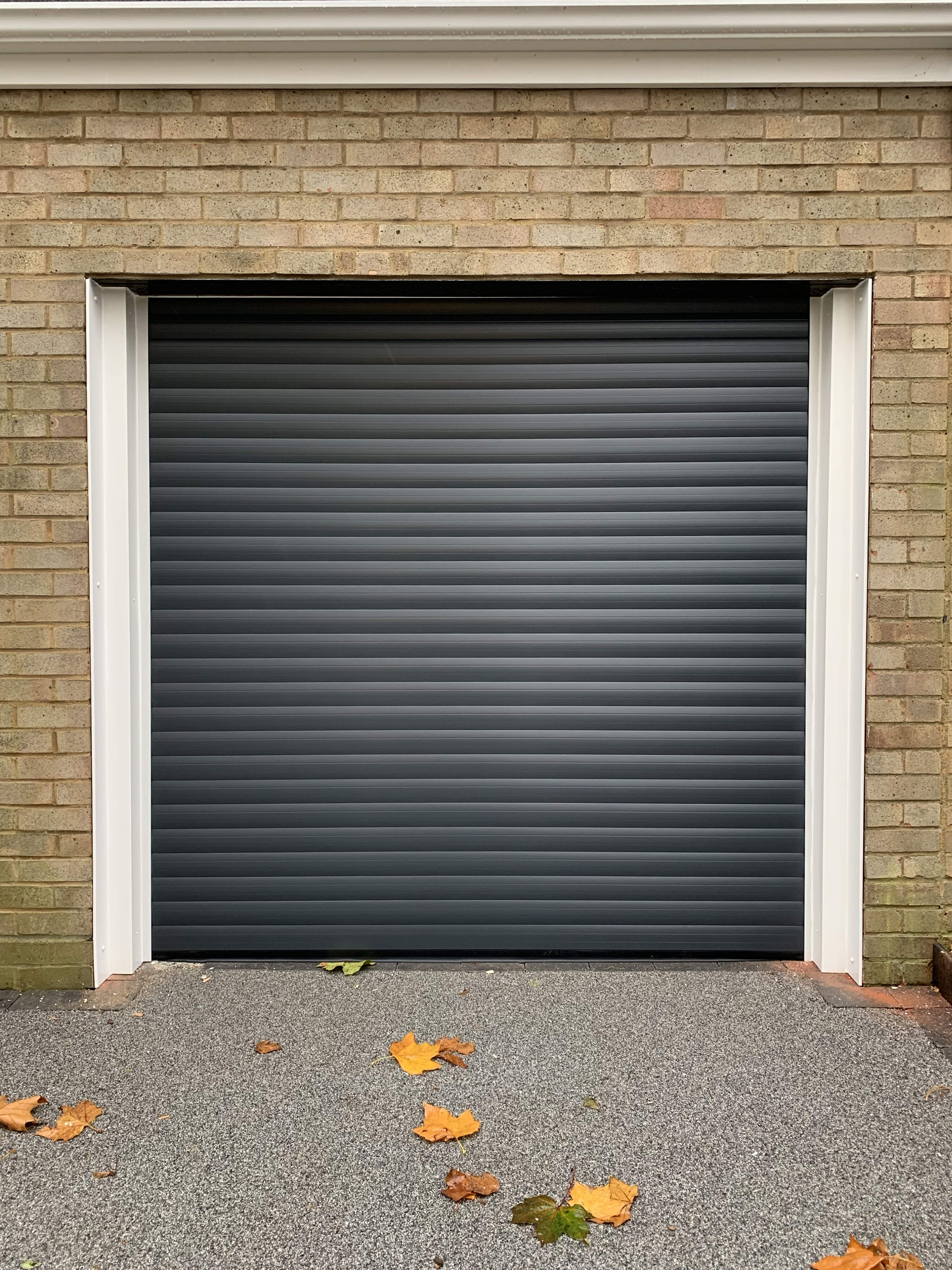 Single Insulated 77mm Lath (Anthracite Grey) Roller Shutter Garage Door with White Frame.