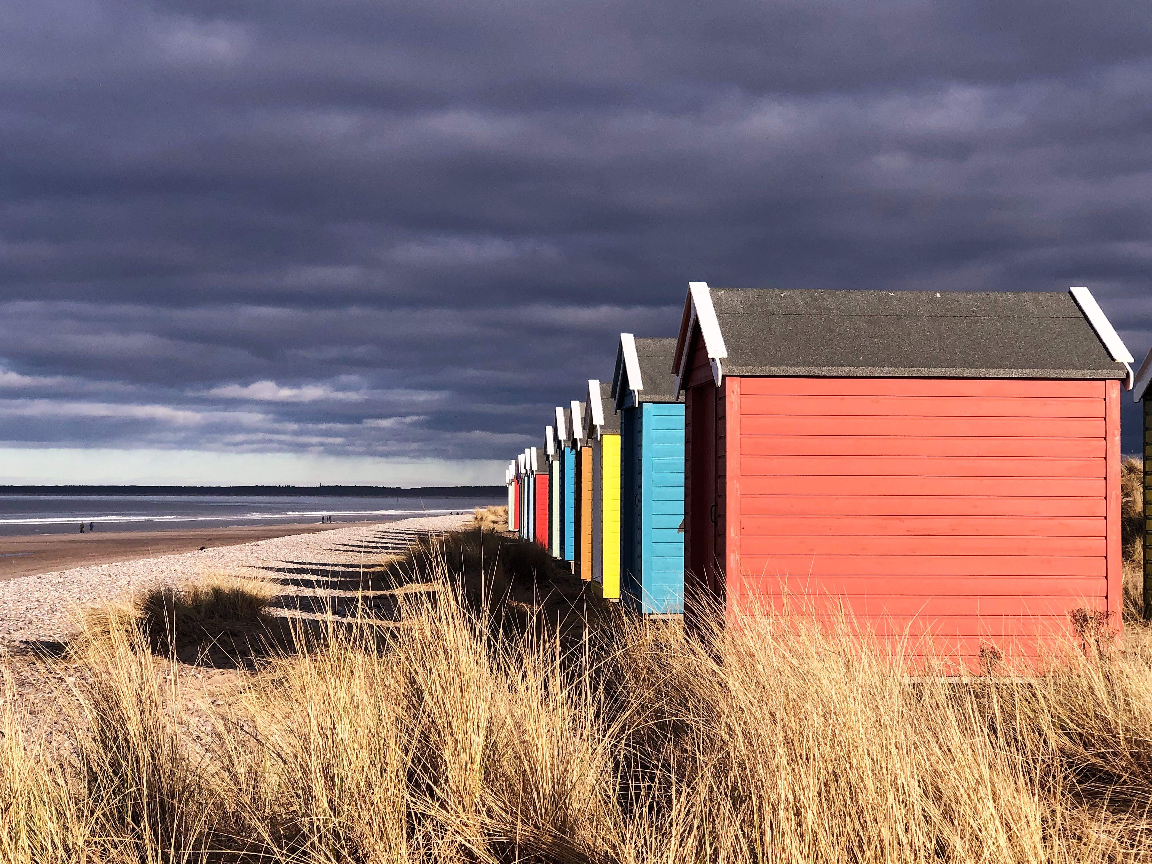 The playful colours of the beach huts on Findhorn Beach