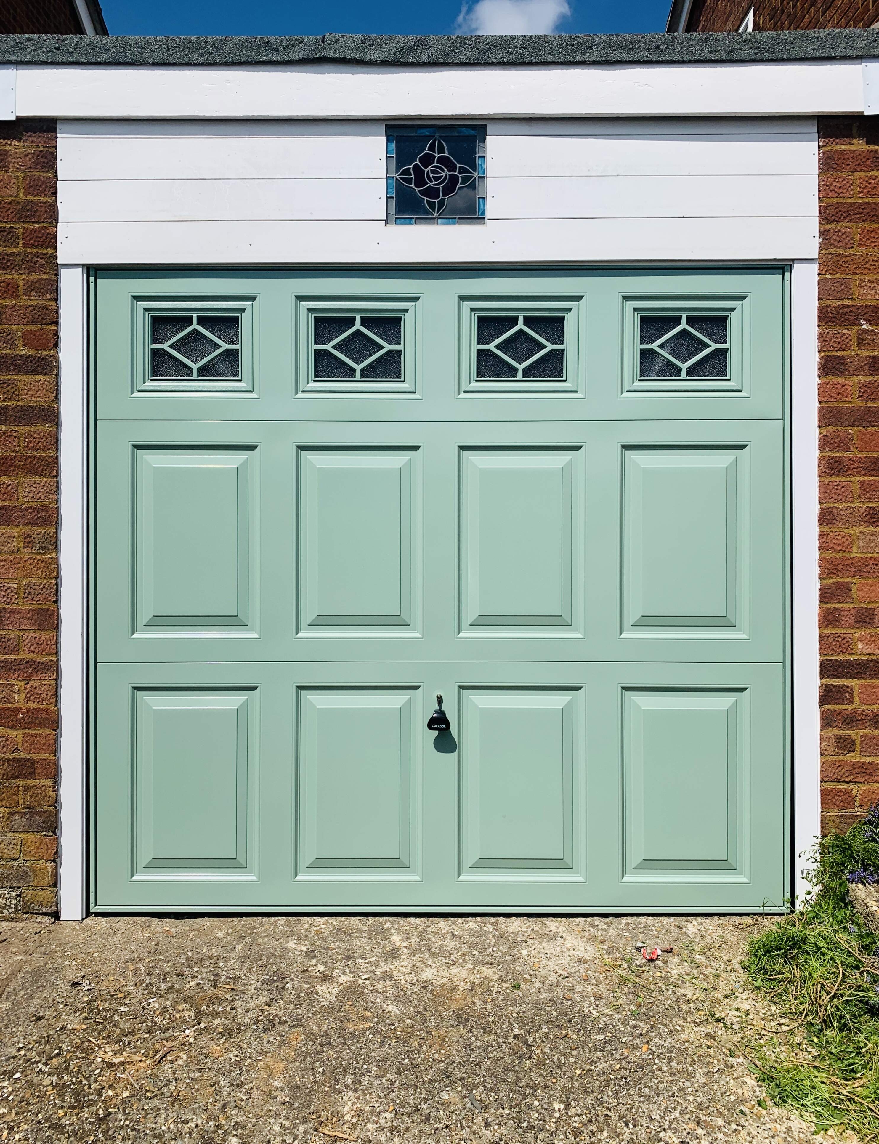 Single Steel (Chartwell Green) Beaumont Canopy Garage Door with White Frame & Diamond Windows.