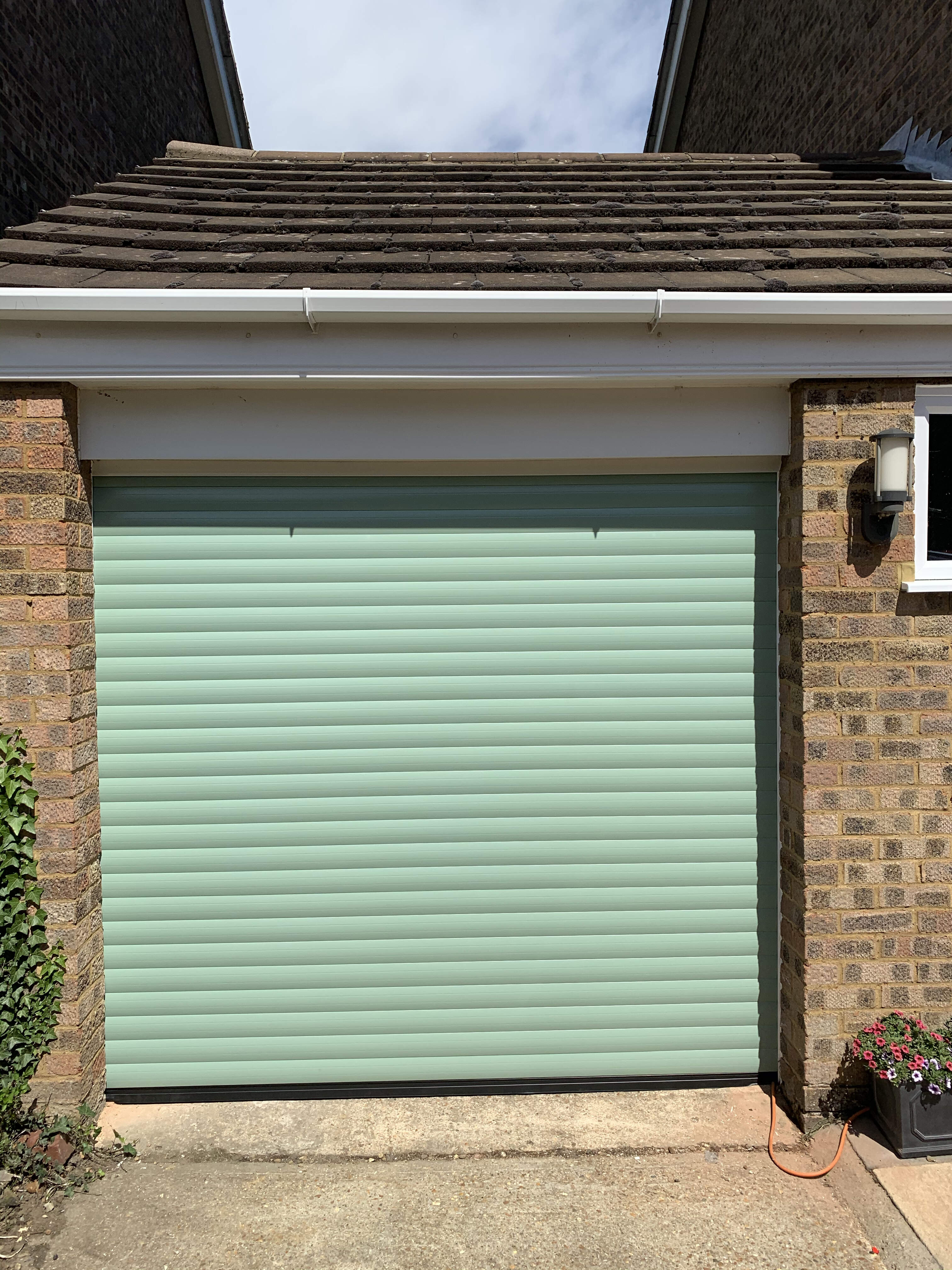 Single Insulated 77mm Lath (Chartwell Green) Roller Shutter Garage Door with White Frame.